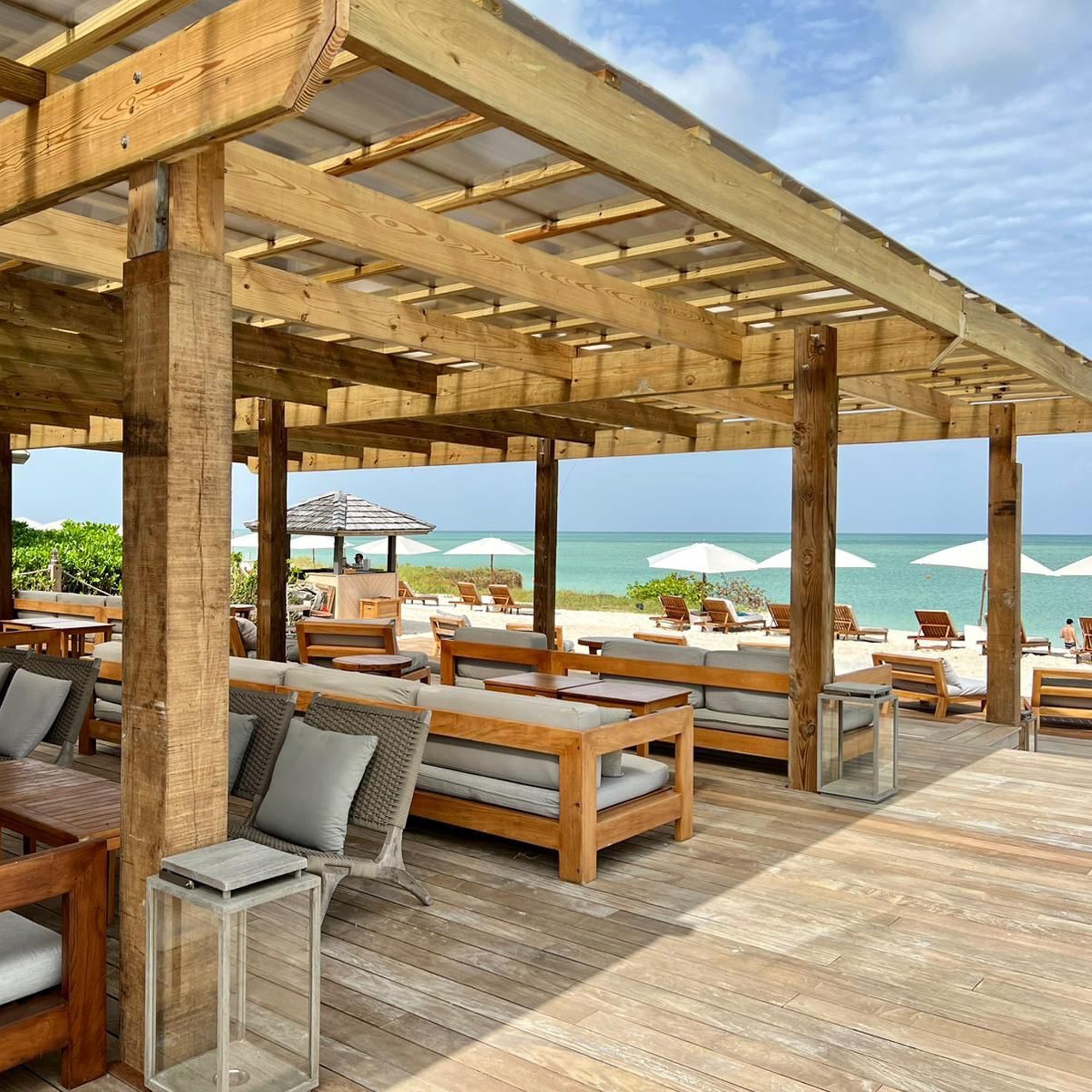 Bronze retractable awning shading a beach-house patio